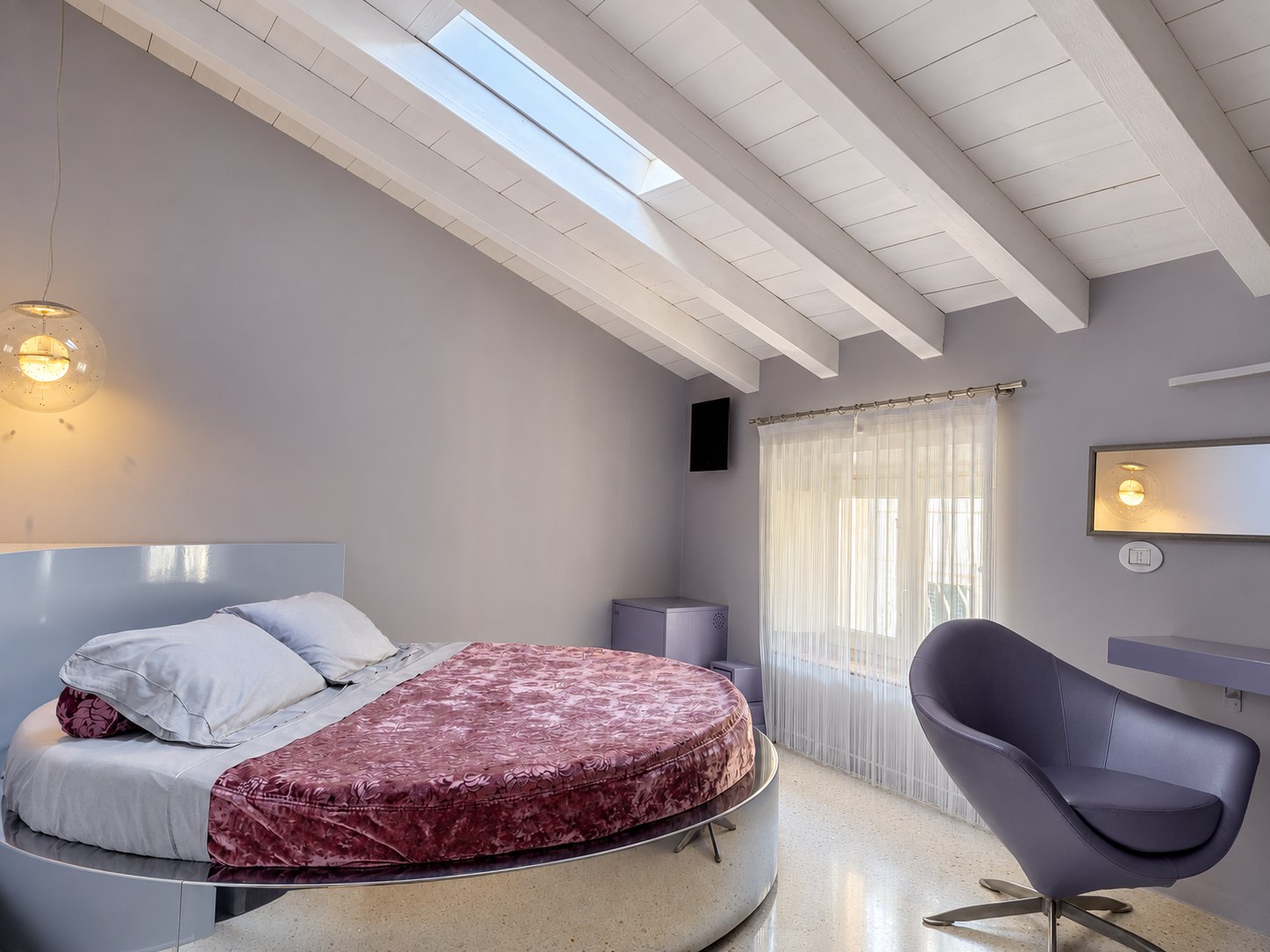 Suite Moderna — Bedroom with an oval double bed and white beams